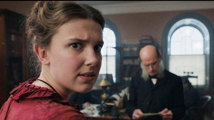 Enola Holmes (Millie Bobby Brown) tries to get a message sent to her mother through a London newspaper. She breaks the fourth wall to explain to the audience why she feels like the newspaper is the best way to communicate with her missing mother.