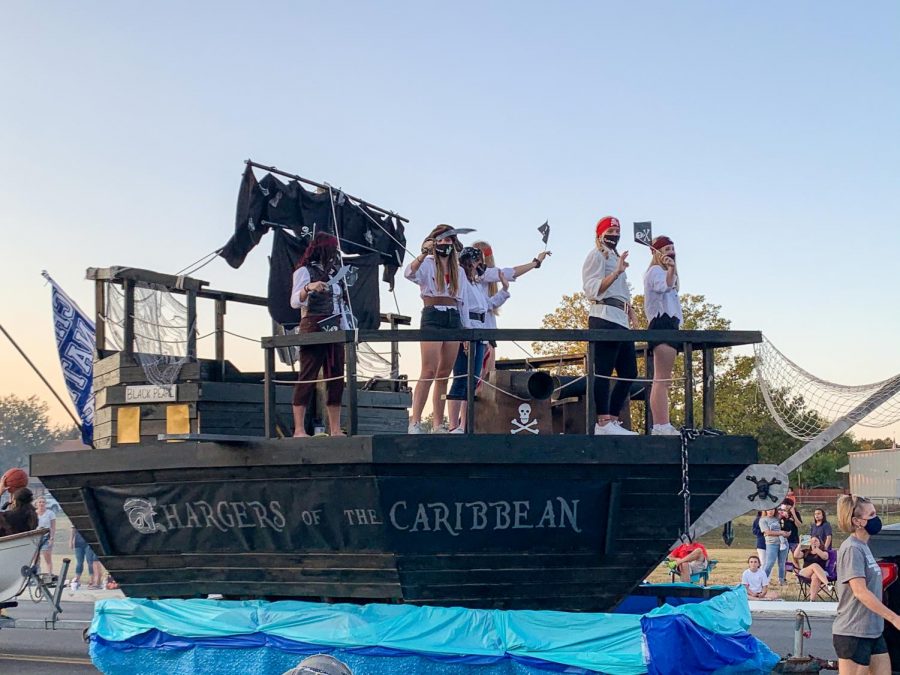 CHS+Girls+Basketball+won+first+place+during+the+2020+homecoming+parade+with+their+Chargers+of+the+Caribbean+boat+float.+The+girls+and+parents+dedicated+many+weekends+to+build+this+winning+float.+The+float+was+equipped+with+cannons+shooting+basketballs%2C+a+sound+system%2C+and+a+dinghy+trailing+behind.