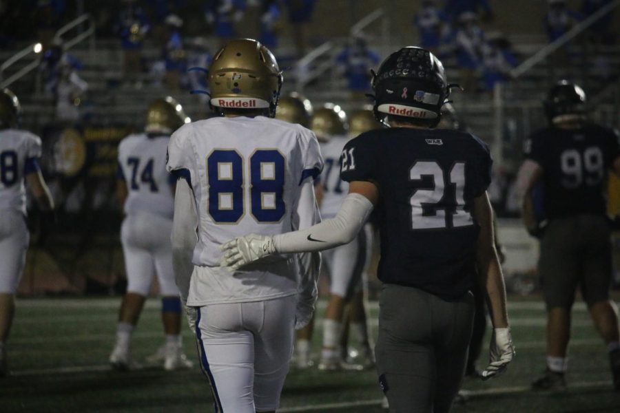 During the Champion vs. Heights game, two opposing players, #88 AAHS senior John York and #21 CHS senior Caleb Surber, show comradeship and good sportsmanship. Both teams worked side by side to create a fun game experience for the audience and the players.