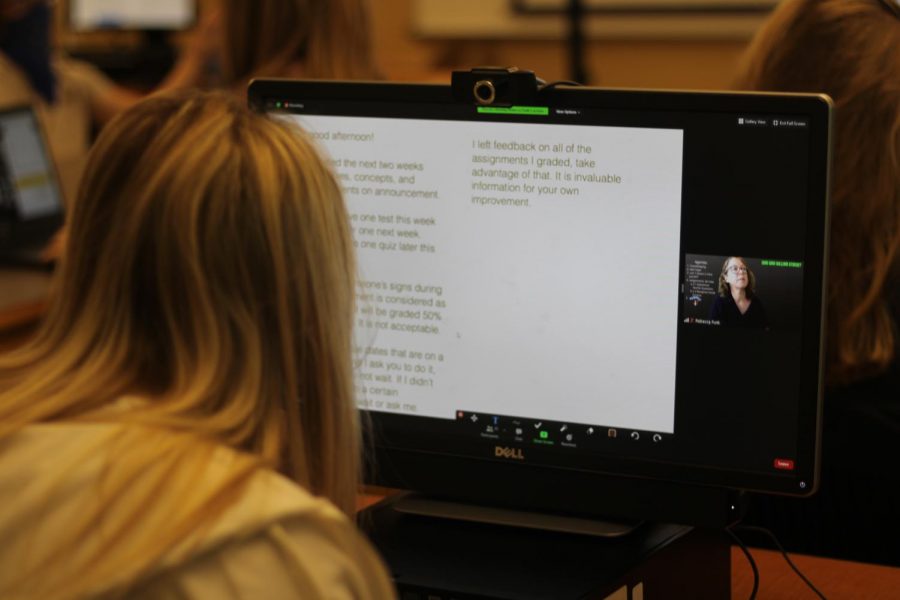 Sophomore Vallerie Miller watches her screen as the teacher types instructions. Because the students arent yet fluent in ASL, Ms. Rebecca, the ASL teacher, writes what she has to say.