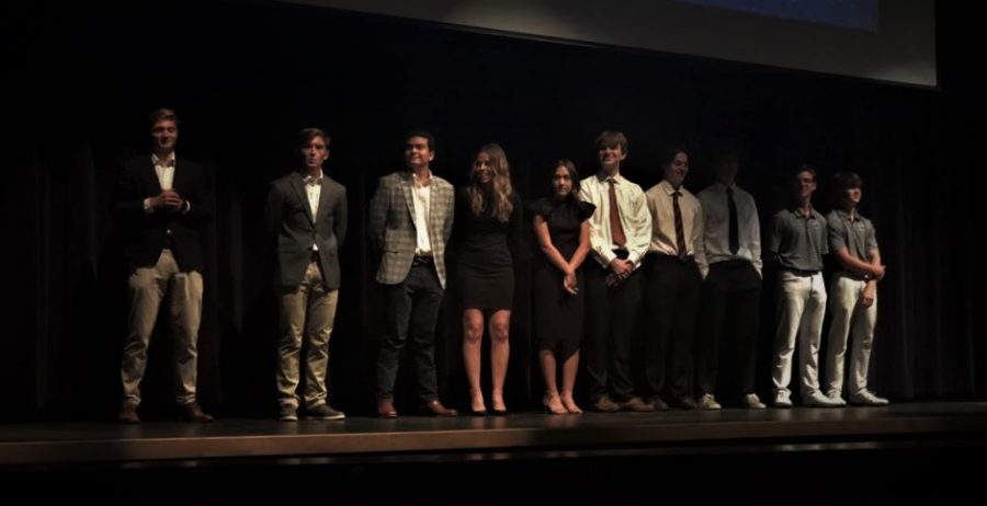 All four teams are lined up on stage after pitching their products to the audience and judges. They are waiting for the winners to be announced.