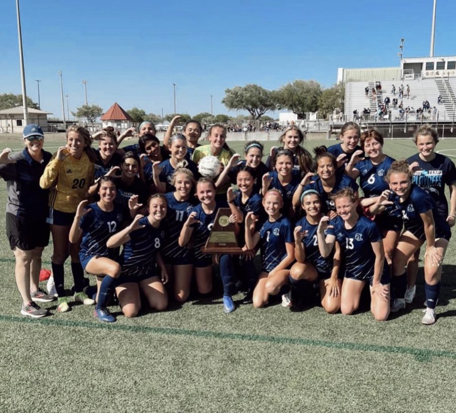 The girls soccer team poses with our signature Charger C in Corpus Christi after winning the game that allowed them to go to state.