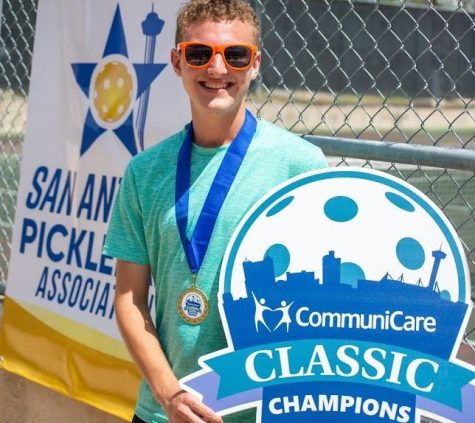 Riley Williamson, who won the tournament, posing by the pickleball court.