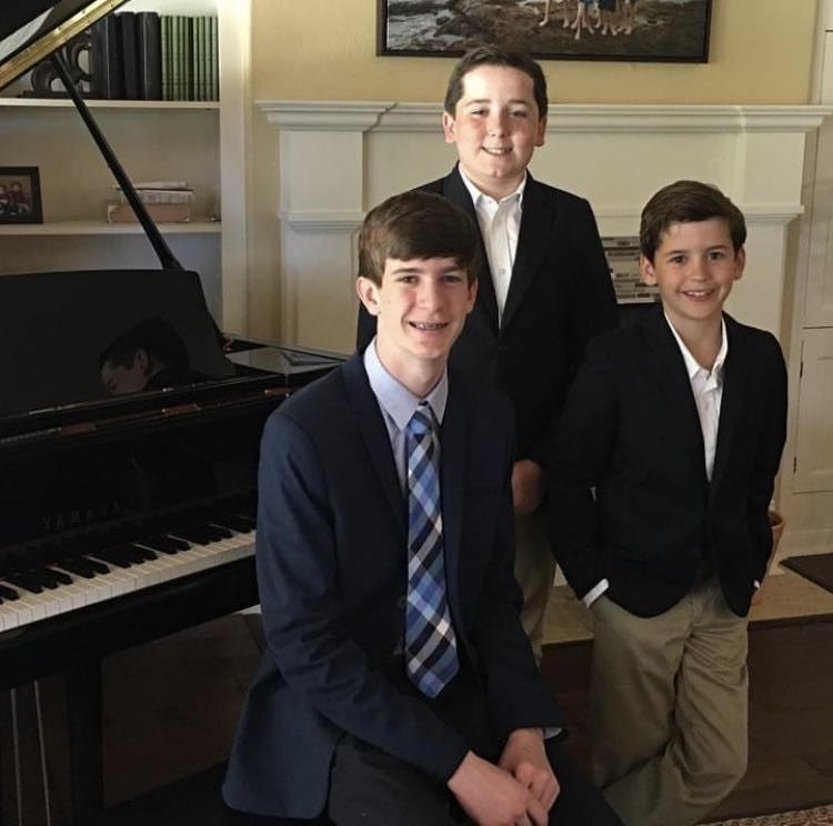 Max Moreland and his older brothers taking a picture before they head to a recital. 
