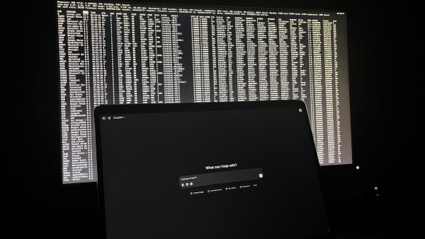 ChatGPT on laptop screen with a “hacking” screen behind it.
